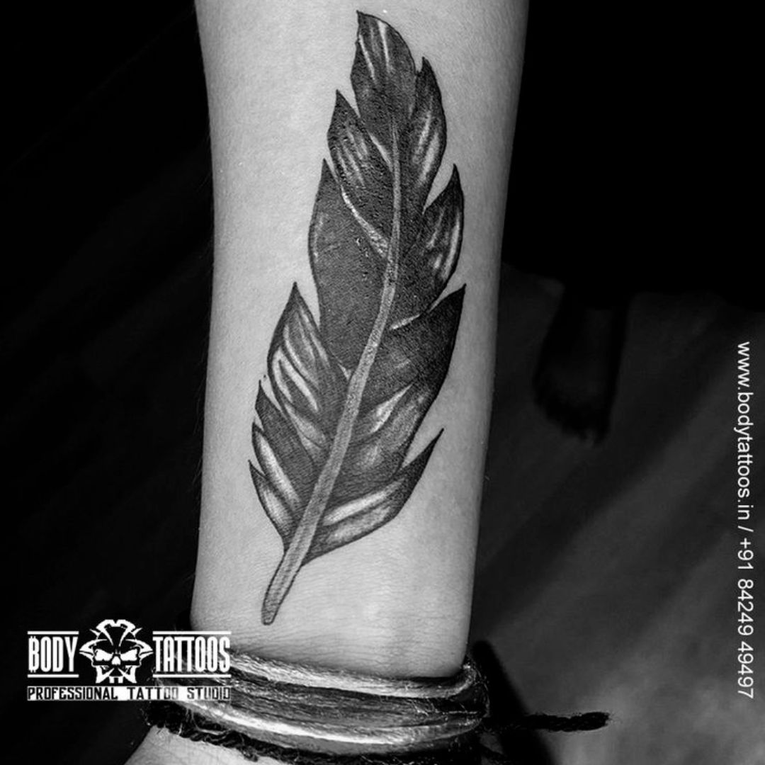 feather cover up tattoo on forearm made in body tattoo studio kalyan